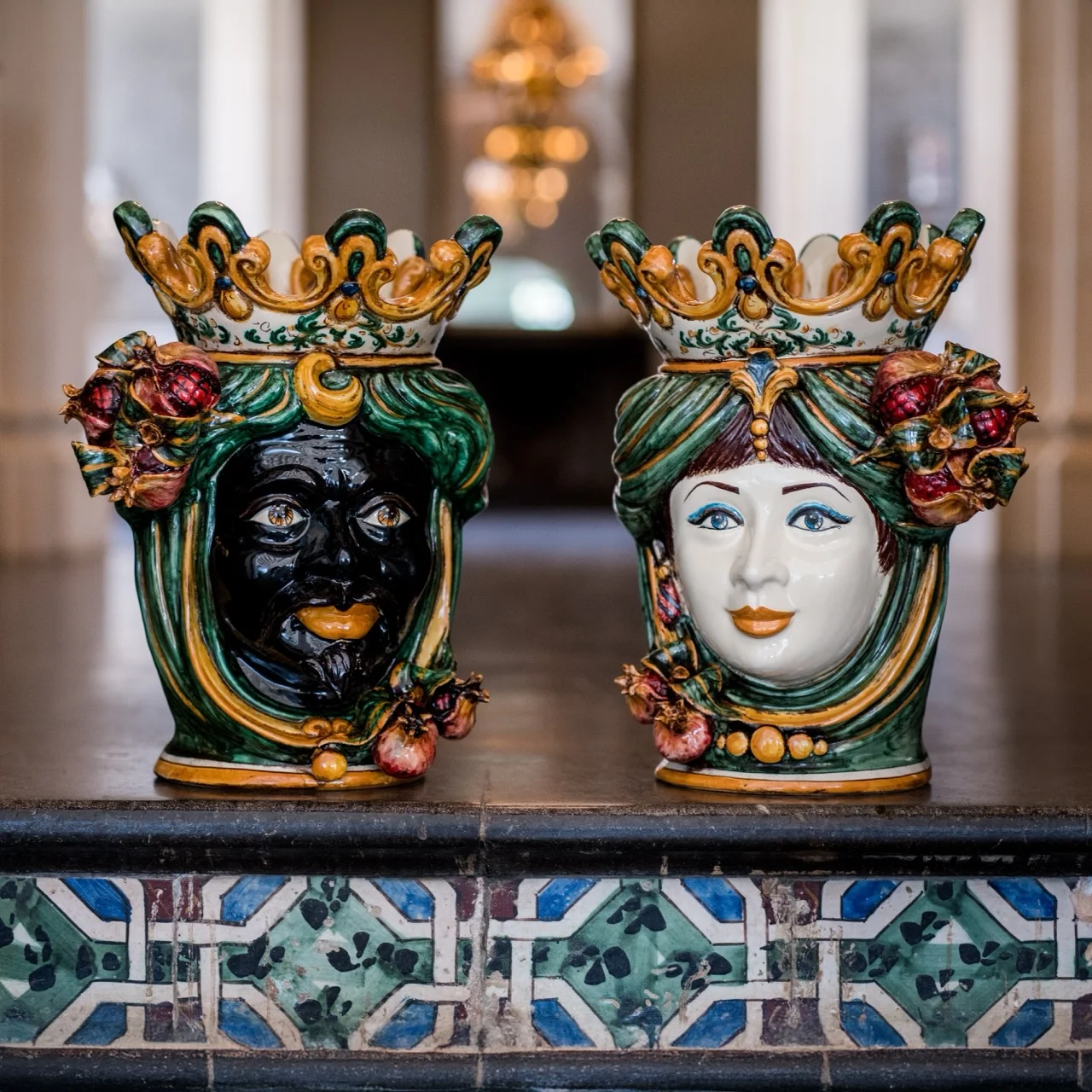 Pair of hand-painted Caltagirone Moor's head vases with green and gold crowns and pomegranate details